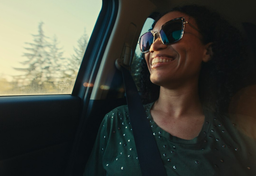 Smiling Croatian woman with sunglasses on her head outdoors in natural light
