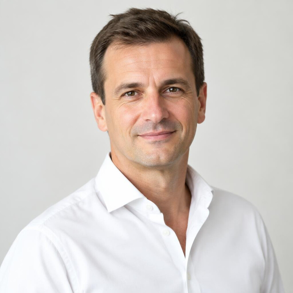 Portrait of a Croatian man in his forties with short brown hair and a white shirt