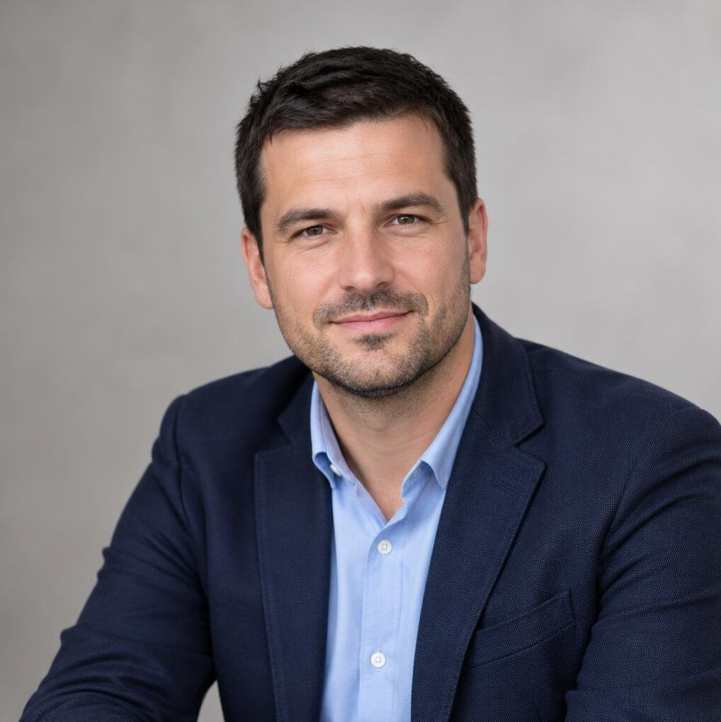 Portrait of a Croatian man in his late thirties in a business casual jacket in a bright office