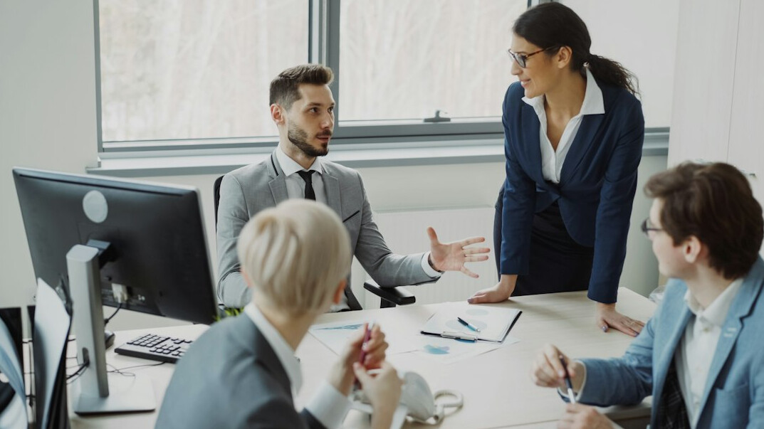 business manager leading team meeting